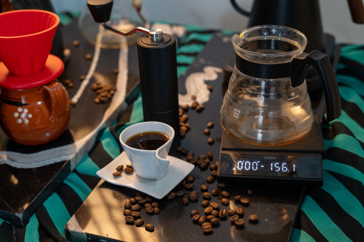 Manuelle Kaffeemühle mit frischen Bohnen für die Zubereitung