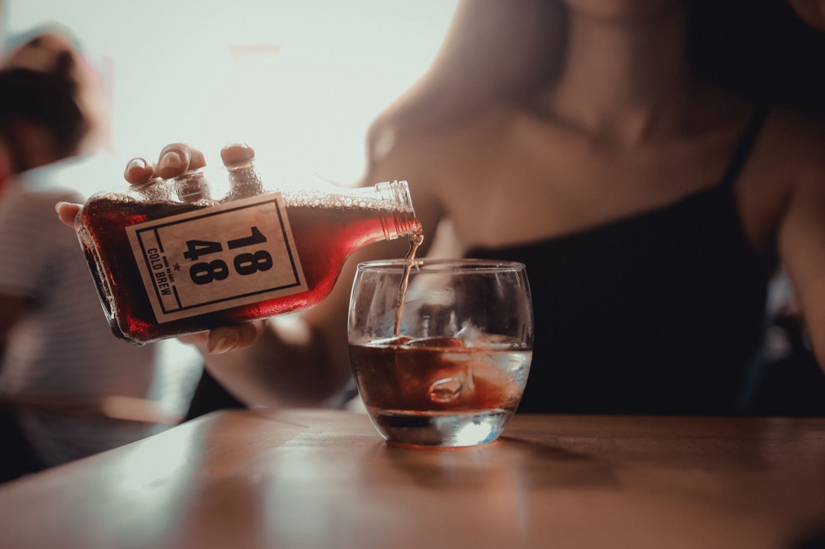 A glass bottle filled with prepared cold brew coffee