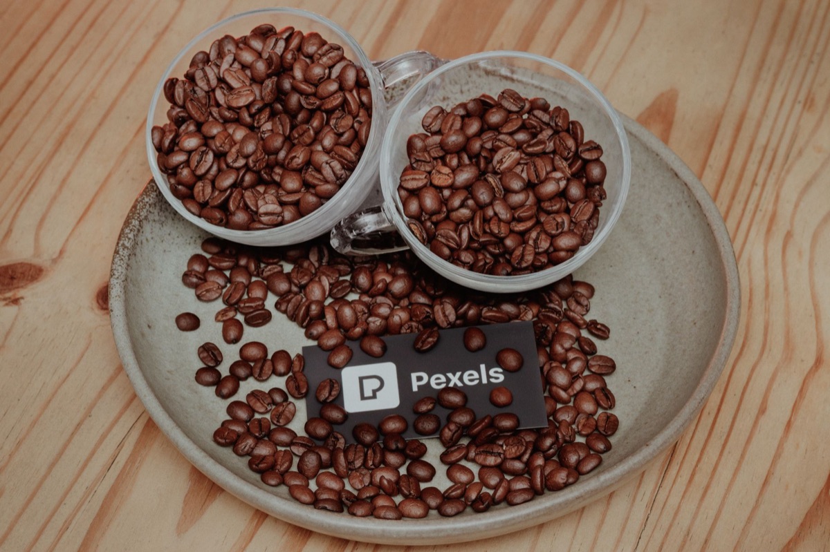 Arabica and Robusta coffee beans on a wooden table