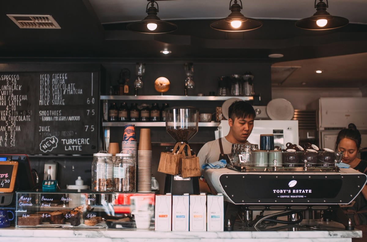 Coffee shop interior with barista preparing beans